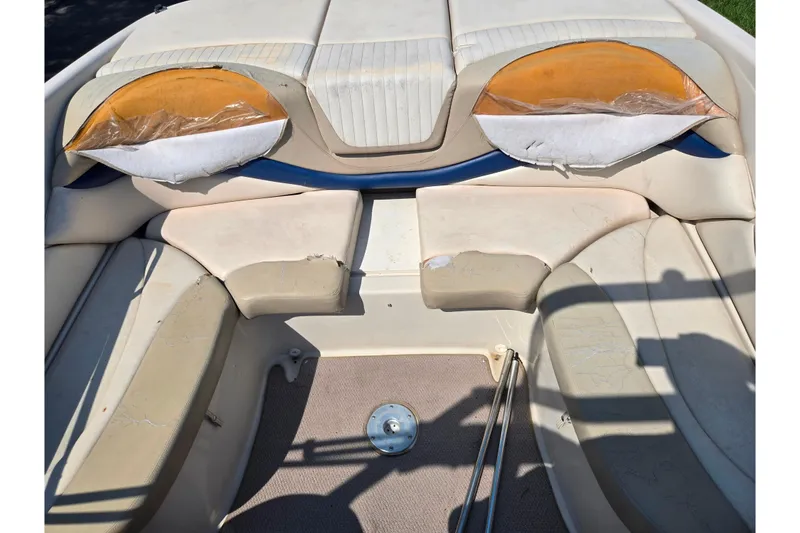 Slide: The Image of 2005 Glastron GX 235 boat interior with worn seating and visible damage. - 23