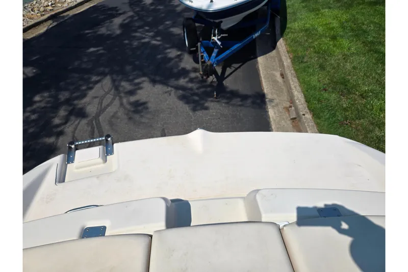Slide: The Image of 2005 Glastron GX 235 boat on trailer, parked on a paved road. - 26
