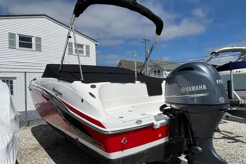 Slide: The Image of 2020 Hurricane SunDeck 191 OB boat with Yamaha 115 engine, docked outdoors. - 2