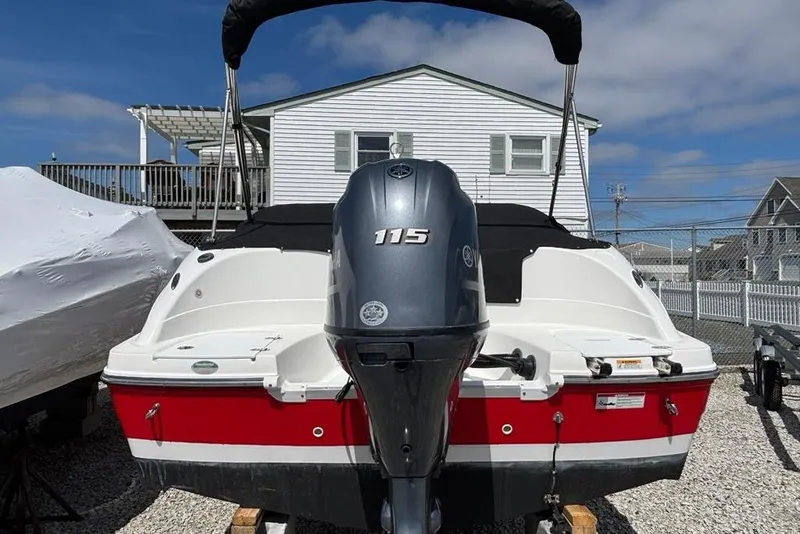 Slide: The Image of 2020 Hurricane SunDeck 191 OB boat with 115 HP outboard motor, parked outdoors. - 3