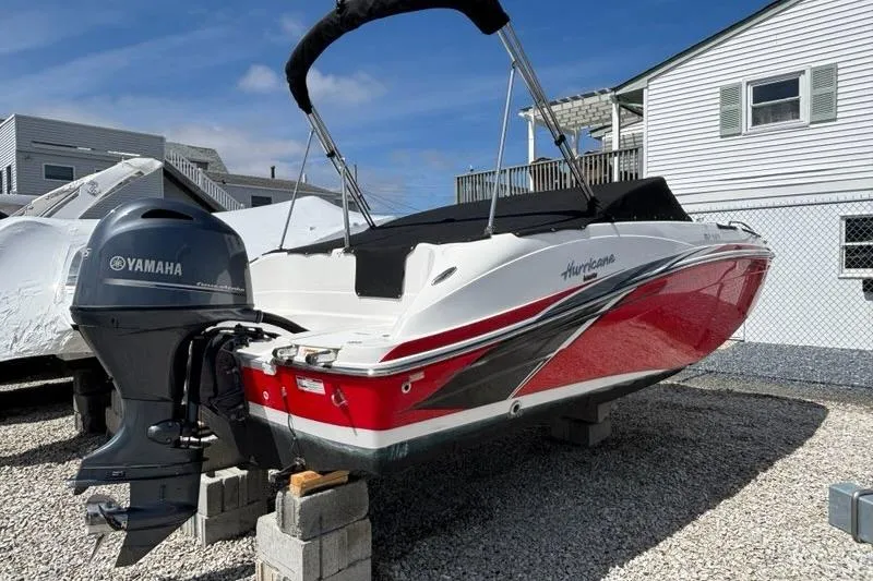 Slide: The Image of 2020 Hurricane SunDeck 191 OB boat with Yamaha outboard motor, parked on blocks. - 4