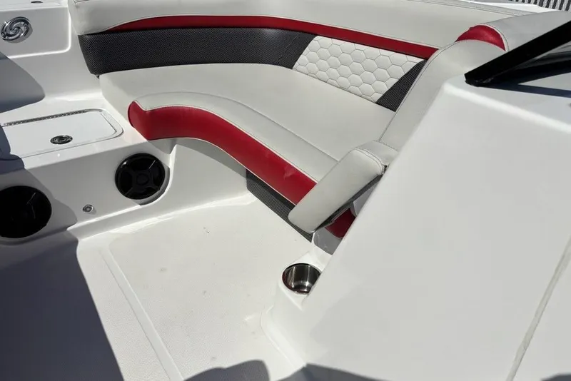 Slide: The Image of 2020 Hurricane SunDeck 191 OB boat interior with red and white seating and cup holder. - 6