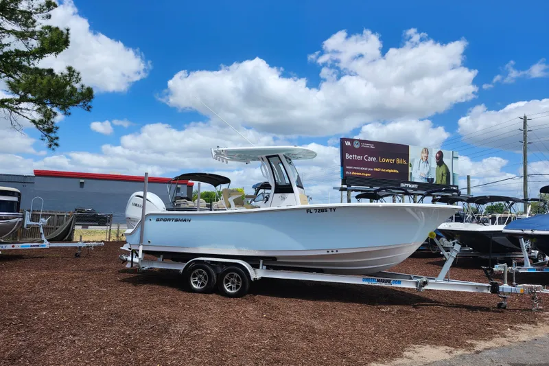 The Image of 2024 Sportsman Open 232 Center Console boat on trailer under blue sky. - 1