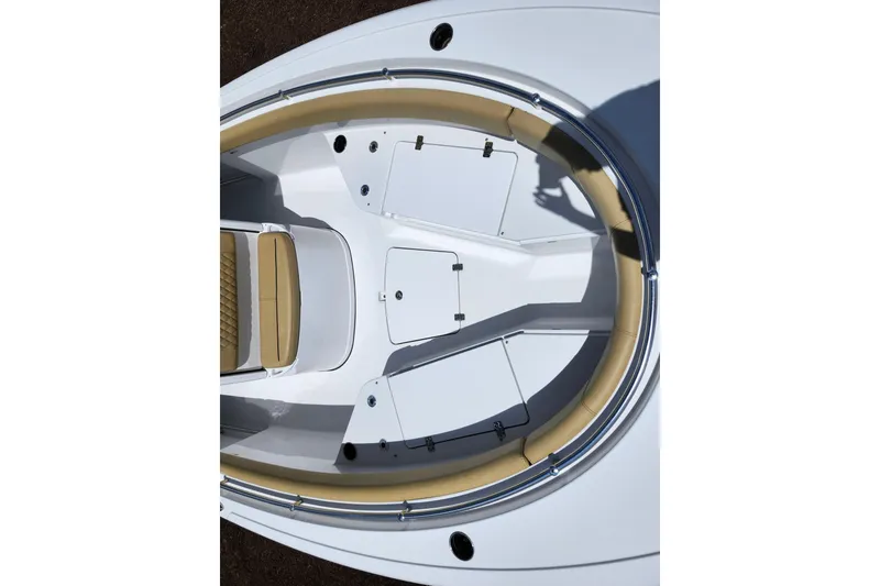 Slide: The Image of 2024 Sportsman Open 232 Center Console boat interior with tan seating and storage compartments. - 13