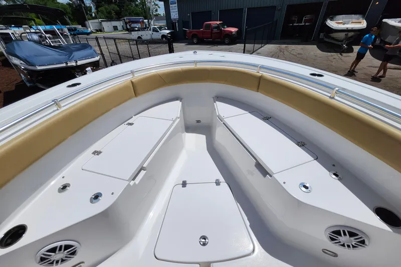 Slide: The Image of 2024 Sportsman Open 232 Center Console boat interior with cushioned seating and storage compartments. - 15