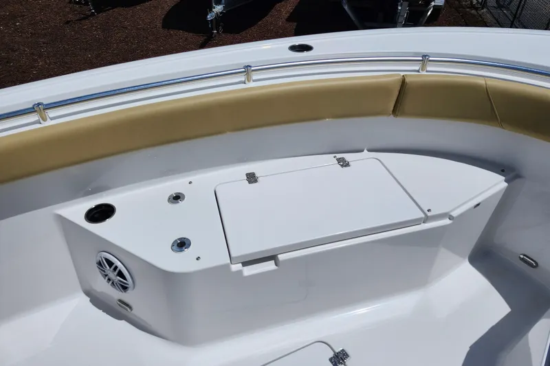 Slide: The Image of 2024 Sportsman Open 232 Center Console boat interior with cushioned seating and storage compartment. - 16