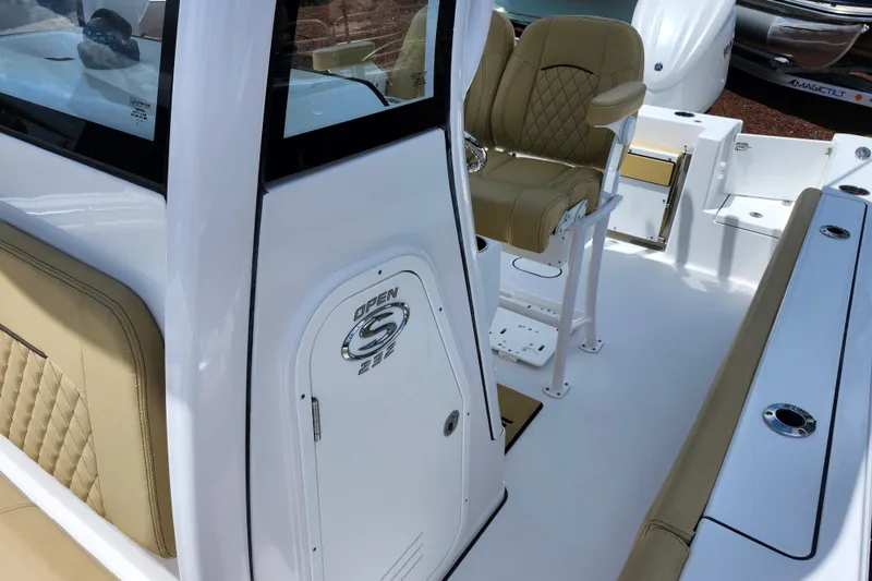 Slide: The Image of 2024 Sportsman Open 232 Center Console boat interior with tan seating and sleek design. - 23