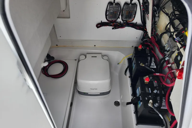 Slide: The Image of 2024 Sportsman Open 232 Center Console boat interior with batteries and wiring. - 26