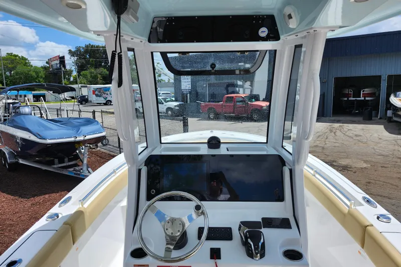 Slide: The Image of 2024 Sportsman Open 232 Center Console boat dashboard with steering wheel and controls. - 27