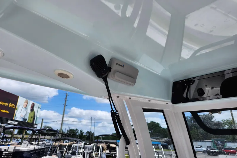 Slide: The Image of 2024 Sportsman Open 232 Center Console interior with Garmin equipment and microphone. - 30