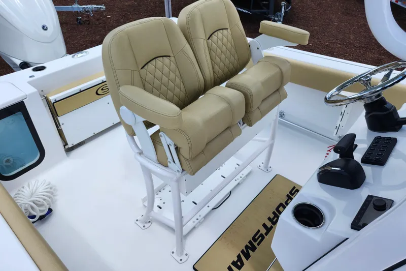 Slide: The Image of 2024 Sportsman Open 232 Center Console with tan seating and modern helm controls. - 33