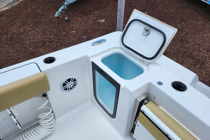 Slide: The Image of 2024 Sportsman Open 232 Center Console boat with open storage compartment and speaker. - 34