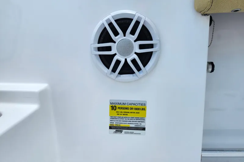 Slide: The Image of 2024 Sportsman Open 232 Center Console speaker and capacity label, 10-person limit. - 36