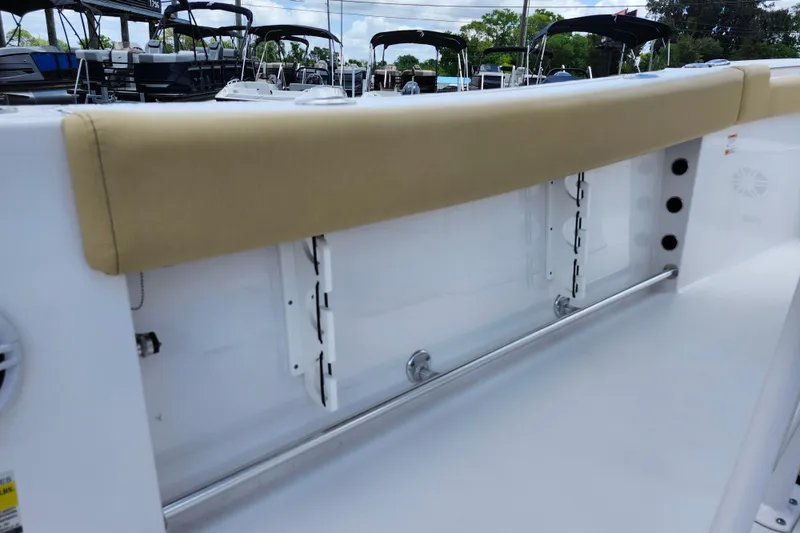 Slide: The Image of 2024 Sportsman Open 232 Center Console boat interior with cushioned seating and rod holders. - 37