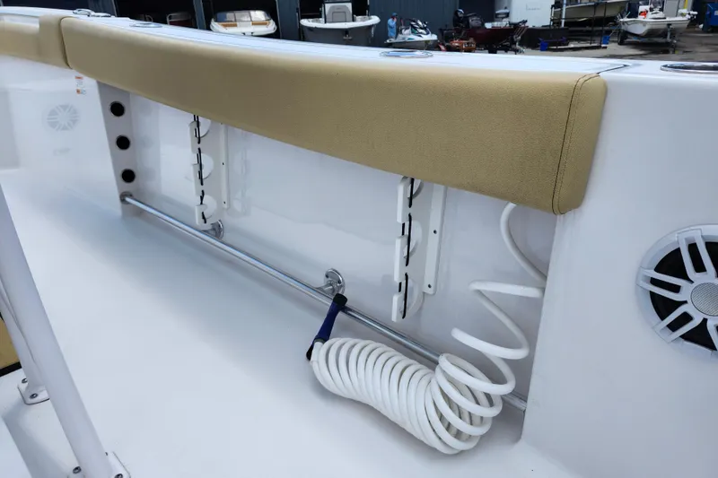 Slide: The Image of 2024 Sportsman Open 232 Center Console interior with coiled hose and cushioned seating. - 38