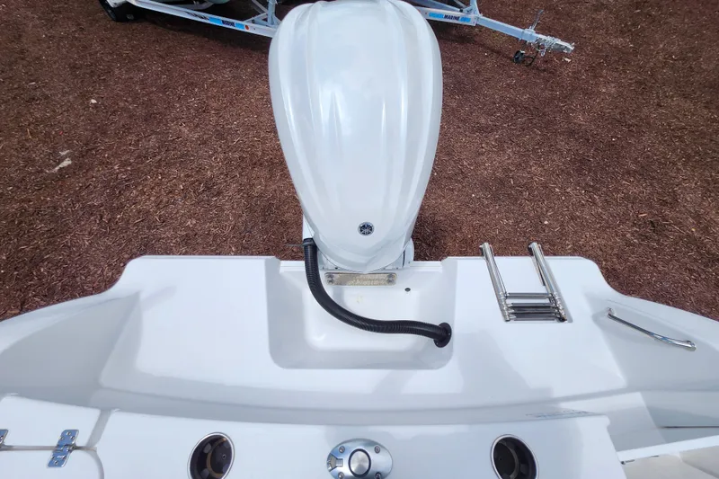 Slide: The Image of 2024 Sportsman Open 232 Center Console boat stern with motor and ladder. - 39