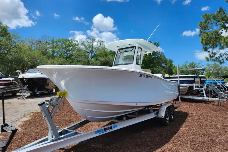 Slide: The Image of 2024 Sportsman Open 232 Center Console boat on trailer under clear blue sky. - 4