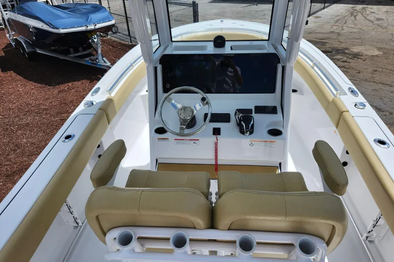 Slide: The Image of 2024 Sportsman Open 232 Center Console boat interior with helm and seating. - 41