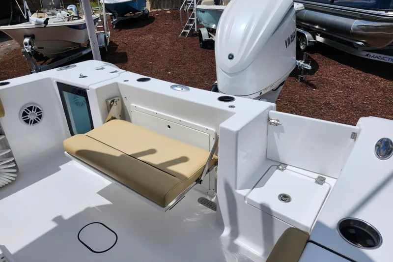 Slide: The Image of 2024 Sportsman Open 232 Center Console boat interior with seating and Yamaha outboard motor. - 43