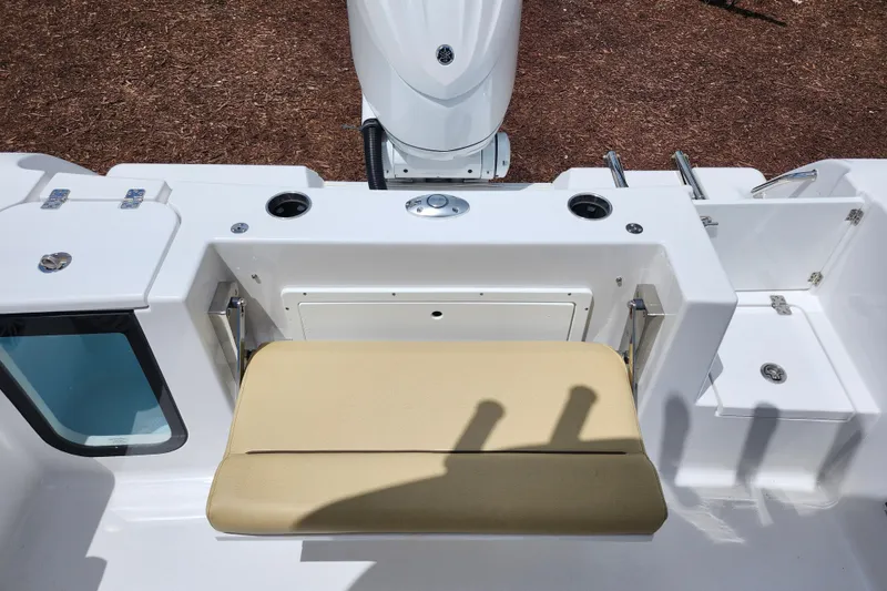 Slide: The Image of 2024 Sportsman Open 232 Center Console boat with beige seating and storage compartments. - 44