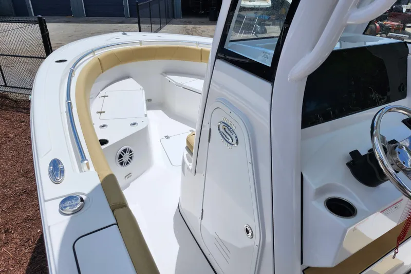 Slide: The Image of 2024 Sportsman Open 232 Center Console boat interior with seating and steering wheel. - 45