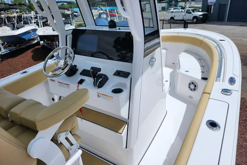 Slide: The Image of 2024 Sportsman Open 232 Center Console boat interior with helm, seating, and modern controls. - 46