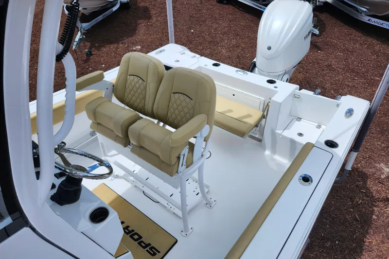 Slide: The Image of 2024 Sportsman Open 232 Center Console boat interior with tan seating and steering wheel. - 49