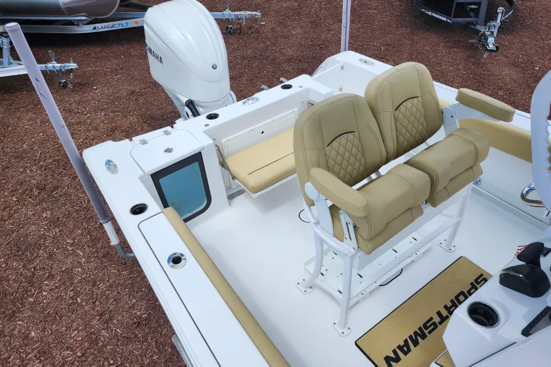 Slide: The Image of 2024 Sportsman Open 232 Center Console boat interior with tan seating and Yamaha engine. - 51