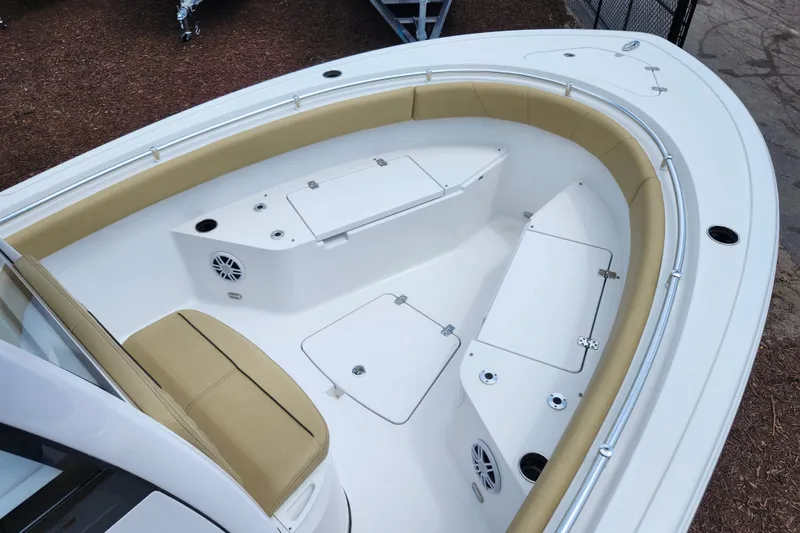 Slide: The Image of 2024 Sportsman Open 232 Center Console boat interior with tan seating and storage compartments. - 52