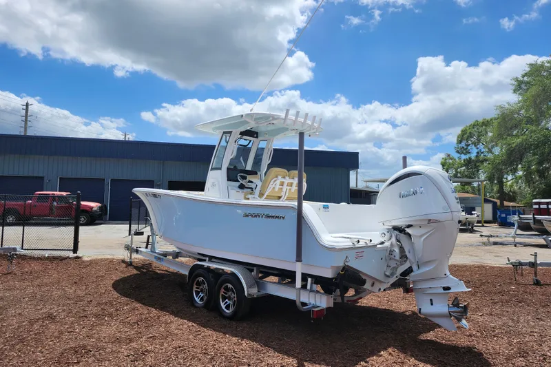 Slide: The Image of 2024 Sportsman Open 232 Center Console boat on trailer under blue sky. - 6
