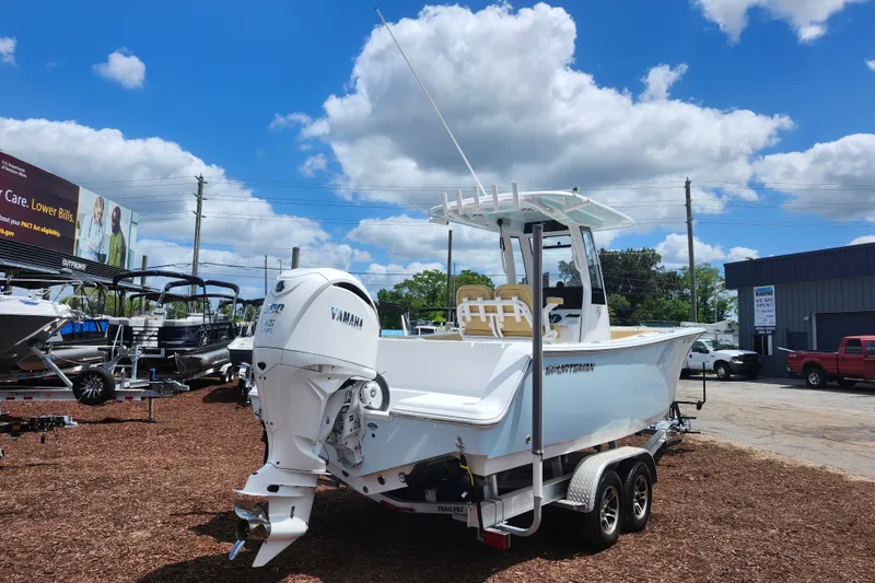Slide: The Image of 2024 Sportsman Open 232 Center Console boat with Yamaha engine on trailer, outdoor display. - 8
