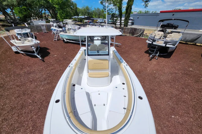 Slide: The Image of 2024 Sportsman Open 232 Center Console boat displayed outdoors, surrounded by other boats. - 9