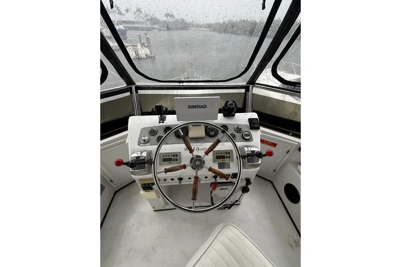 Slide: The Image of Helm of 1988 President 35 Double Cabin boat with steering wheel and navigation equipment. - 11