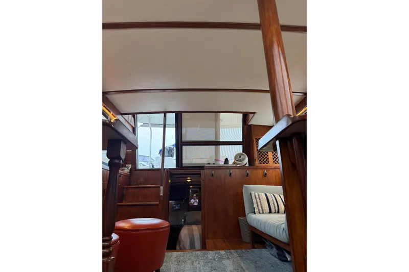 Slide: The Image of Interior of 1988 President 35 Double Cabin yacht with wooden furnishings and seating area. - 13