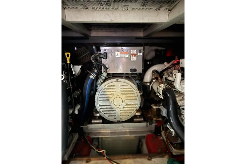 Slide: The Image of Engine compartment of a 1988 President 35 Double Cabin boat, showcasing mechanical components. - 16