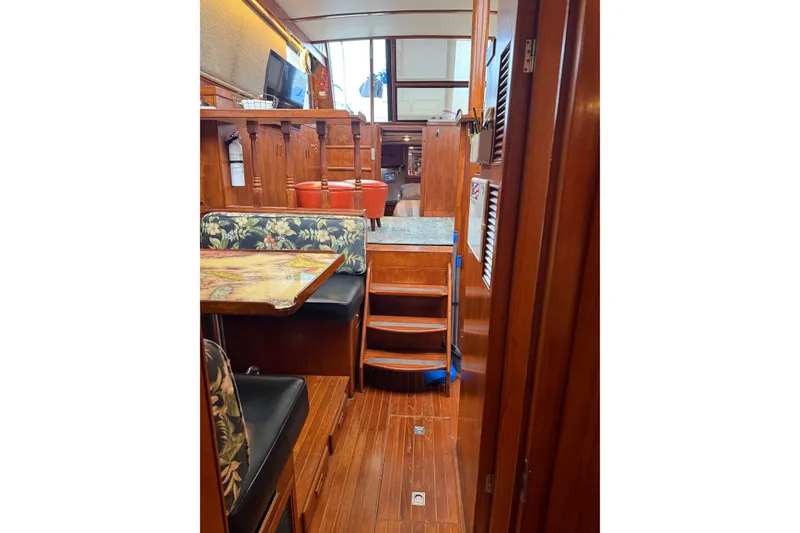 Slide: The Image of Interior of 1988 President 35 Double Cabin yacht with wooden furnishings and seating area. - 17