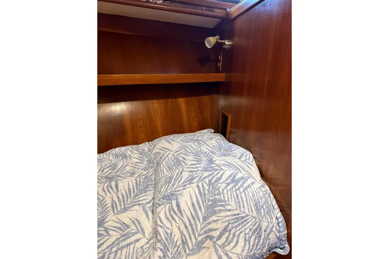 Slide: The Image of Cozy cabin interior of 1988 President 35 Double Cabin with patterned bedding. - 18