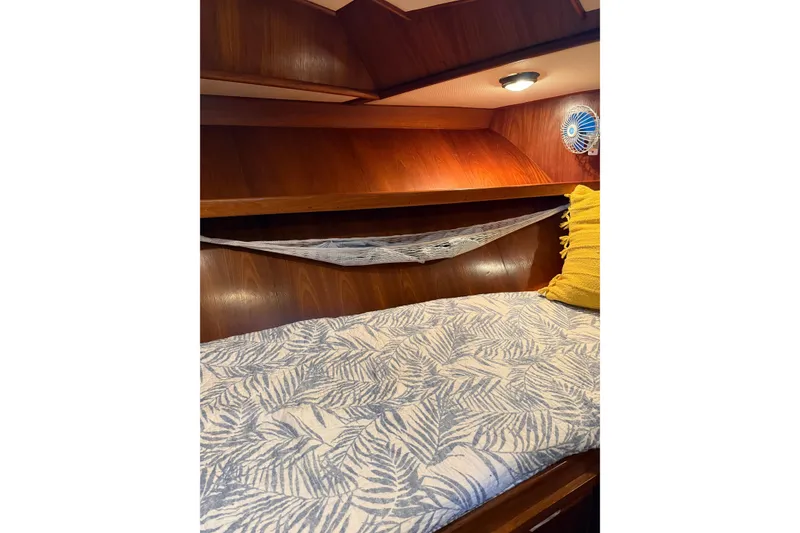 Slide: The Image of Cozy cabin interior of 1988 President 35 Double Cabin with patterned bedding and wooden finish. - 19
