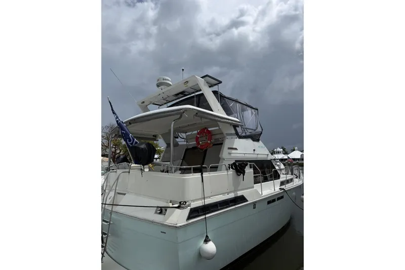 Slide: The Image of 1988 President 35 Double Cabin yacht docked under cloudy skies. - 2