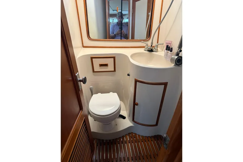 Slide: The Image of Compact bathroom in 1988 President 35 Double Cabin yacht with toilet, sink, and mirror. - 20