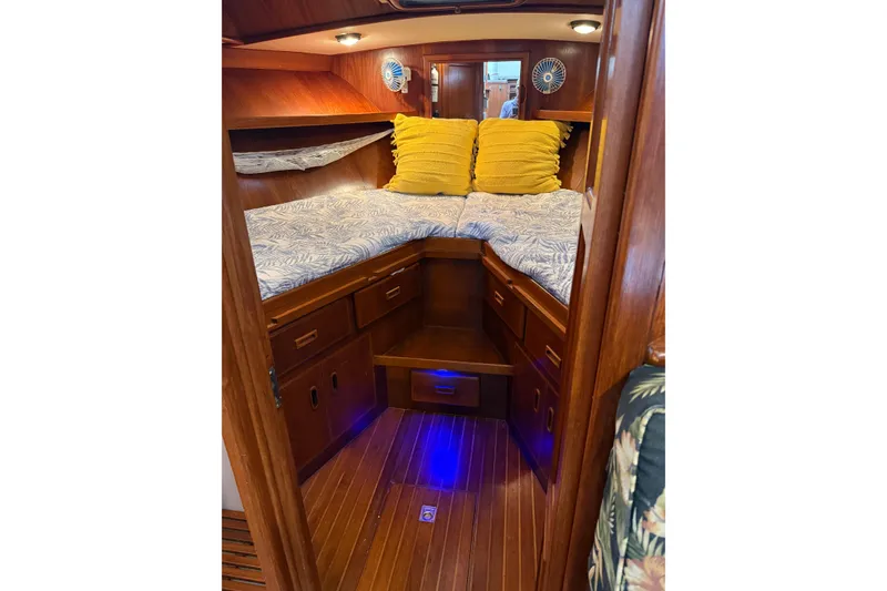 Slide: The Image of Cozy cabin interior of 1988 President 35 Double Cabin yacht with wooden finish and yellow pillows. - 21