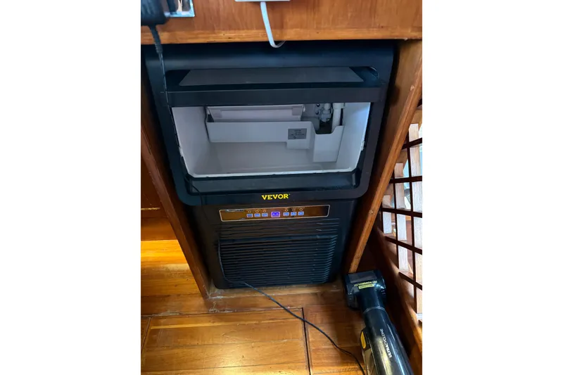 Slide: The Image of Ice maker in 1988 President 35 Double Cabin yacht interior, featuring wooden flooring. - 27