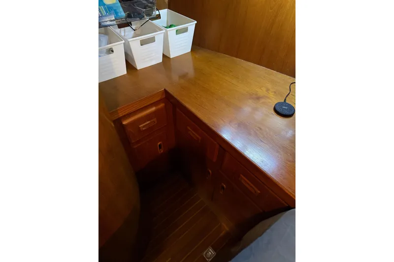 Slide: The Image of 1988 President 35 Double Cabin interior with wooden desk and storage bins. - 28