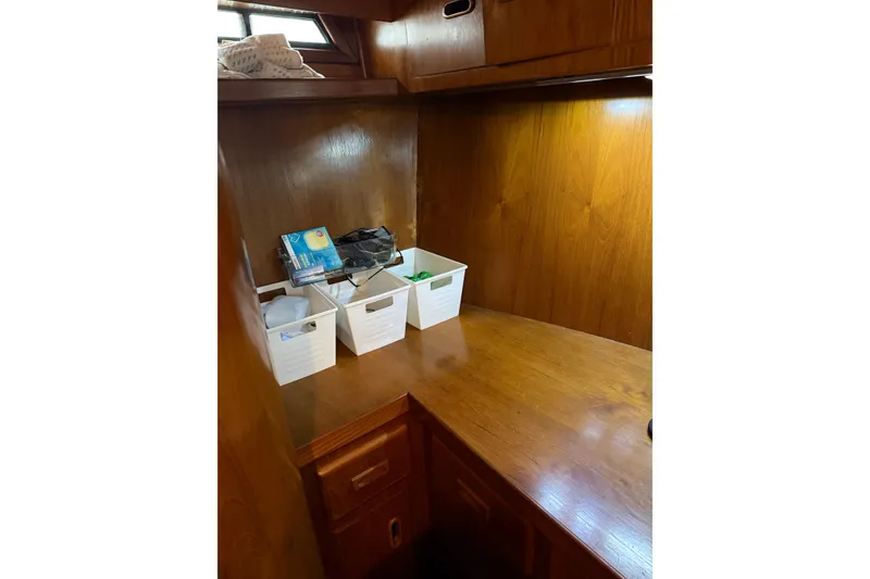 Slide: The Image of 1988 President 35 Double Cabin interior with wooden cabinetry and organized storage bins. - 29