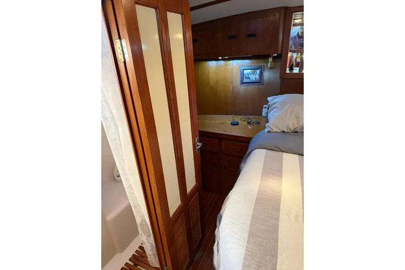 Slide: The Image of 1988 President 35 Double Cabin interior with wooden cabinetry and cozy bed. - 31