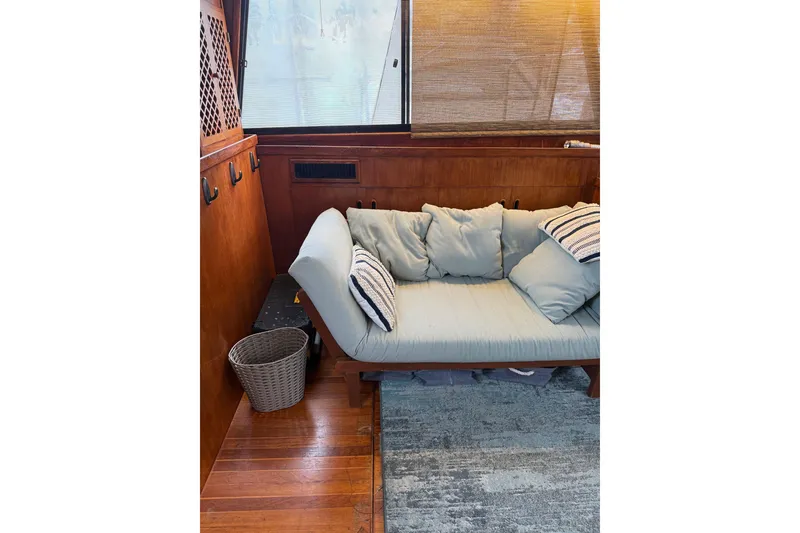 Slide: The Image of Interior of 1988 President 35 Double Cabin with cozy seating and wooden accents. - 35