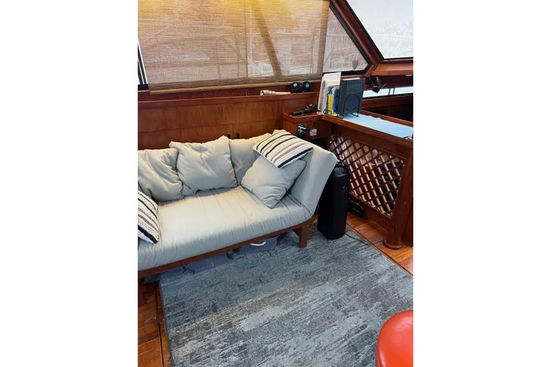 Slide: The Image of Interior of 1988 President 35 Double Cabin with cozy seating and nautical decor. - 36