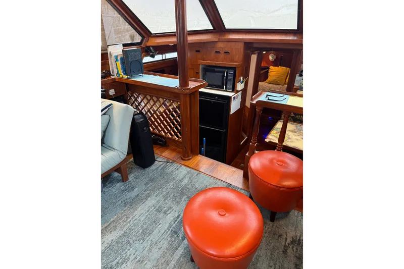 Slide: The Image of Interior of 1988 President 35 Double Cabin yacht with cozy seating and wooden accents. - 37