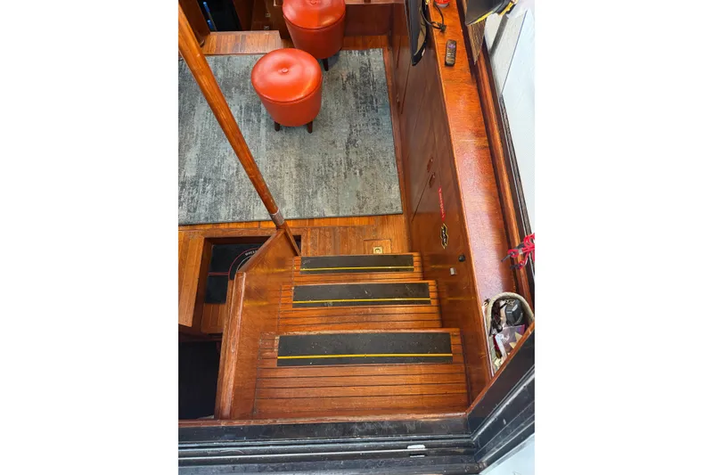 Slide: The Image of Interior of 1988 President 35 Double Cabin yacht with wooden stairs and red stools. - 39