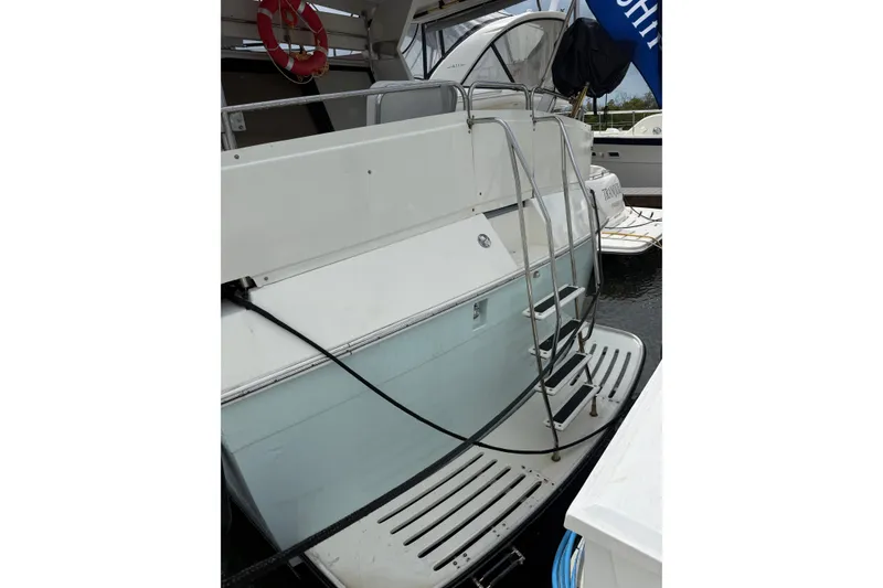 Slide: The Image of 1988 President 35 Double Cabin yacht with ladder and swim platform at dock. - 4